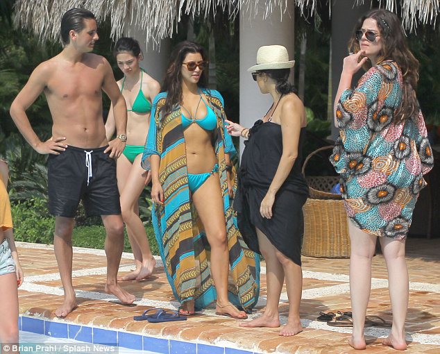 Kim donned a bright turqoise bikini and an elaborate long kaftan on another day of her holiday with her family